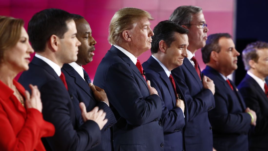 The candidates put their hands over the hearts during the national anthem.