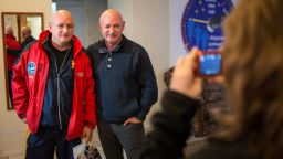 Expedition 43 NASA Astronaut Scott Kelly, left, and his identical twin brother Mark Kelly, pose for a photograph Thursday, March 26, 2015 at the Cosmonaut Hotel in Baikonur, Kazakhstan. Scott Kelly, and Russian Cosmonauts Mikhail Kornienko, and Gennady Padalka of the Russian Federal Space Agency (Roscosmos) are scheduled to launch to the International Space Station in the Soyuz TMA-16M spacecraft from the Baikonur Cosmodrome in Kazakhstan March 28, Kazakh time (March 27 Eastern time.) As the one-year crew, Kelly and Kornienko will return to Earth on Soyuz TMA-18M in March 2016.  Photo Credit (NASA/Bill Ingalls)
