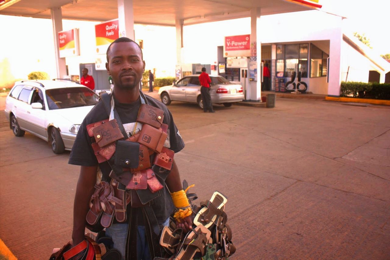 Students have also documented the informal economy which supports many poor people in Kenya. Here, a man sells wallets and sandals at a gas station in Kiambu, near Nairobi.  
