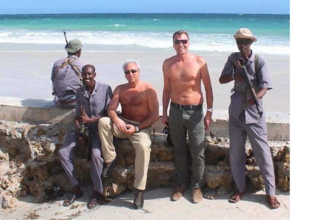2012: Andrew Drury (right) with cousin Nigel Green and Somali security catching rays at the beach in Mogadishu -- his favorite city in the world. 