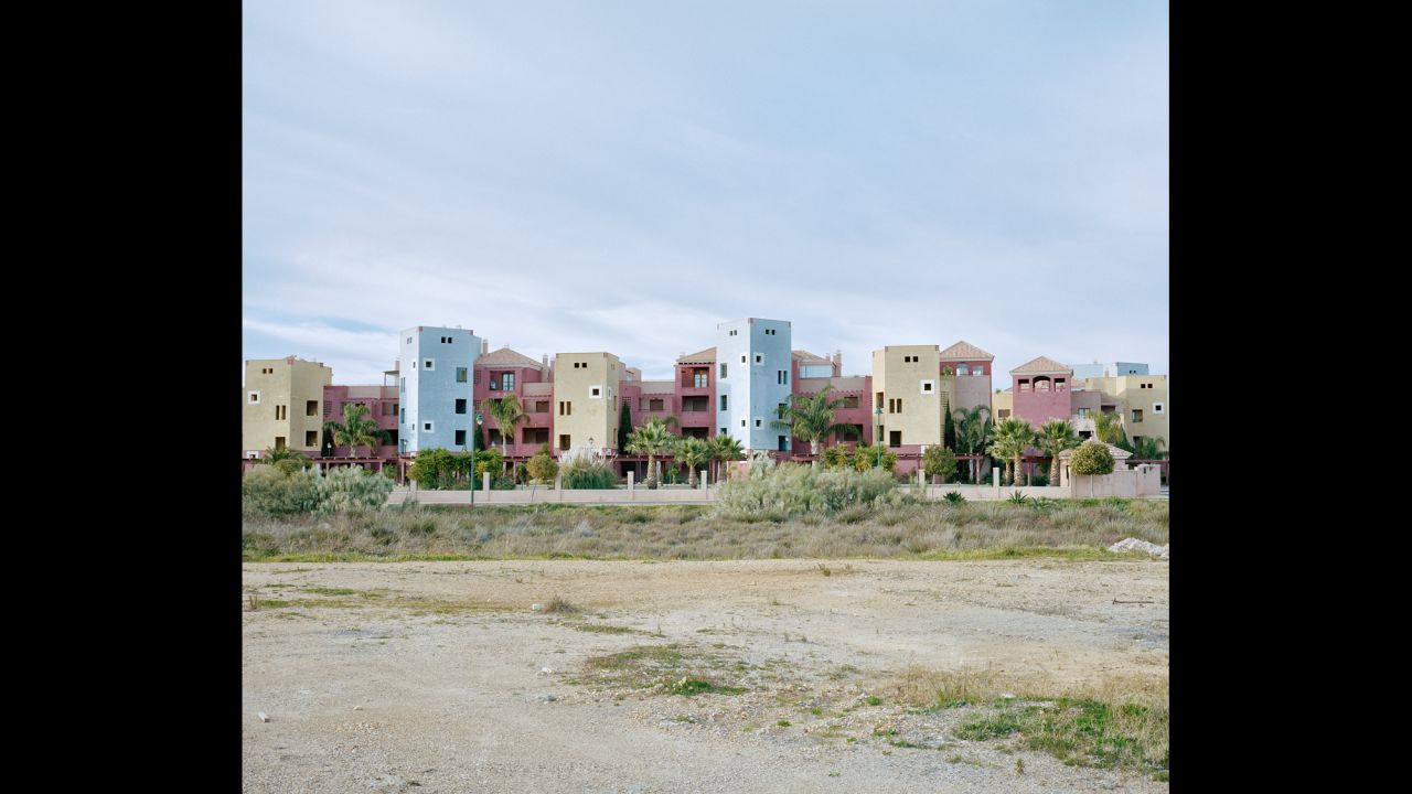 Colorful buildings on a beach in Ayamonte, Spain. Several apartment buildings are empty while some were never completed. "With the entry of the two countries in the European Union and the free circulation of people and goods, the economy of the border towns, despite revitalization attempts, eventually faded," said Colectivo photographer Miguel Proenca.