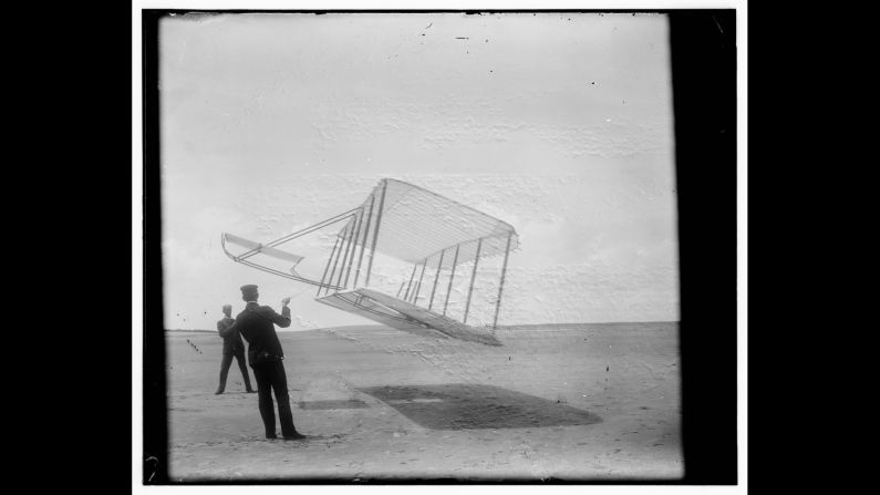Wilbur, left, and Orville fly a glider like a kite in 1901. They tested gliders for a few years before their historic flight in Kitty Hawk.