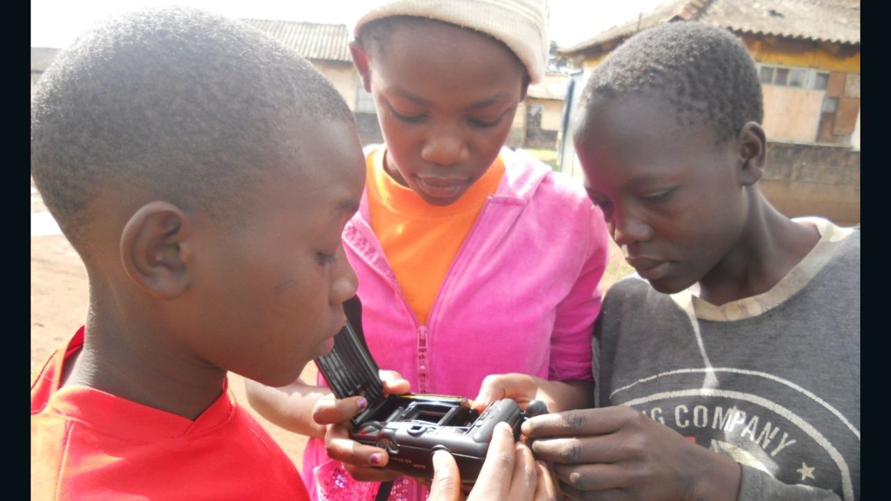 Children play with one of the Mathare Foundation's cameras