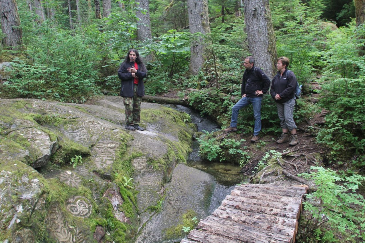 Activities arranged through Tweedsmuir Park Lodge include hikes through old-growth forest with a First Nations guide explaining the meaning of ancient rock petroglyphs (bottom left) near the town of Bella Coola.