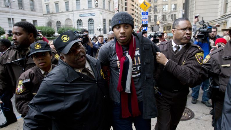 A demonstrator is detained outside a Baltimore courthouse on Wednesday, December 16, after the <a href="index.php?page=&url=http%3A%2F%2Fwww.cnn.com%2F2015%2F12%2F16%2Fus%2Fbaltimore-police-trial-freddie-gray%2Findex.html" target="_blank">mistrial of William Porter,</a> one of six Baltimore police officers charged in connection with the death of Freddie Gray. Jurors said they were deadlocked and unable to reach a unanimous verdict.