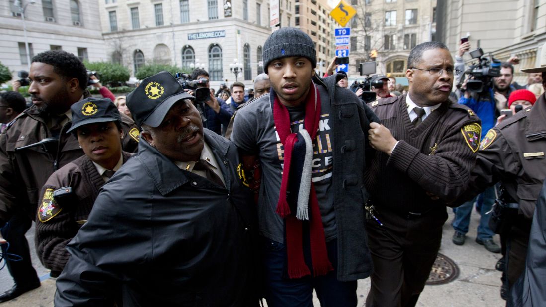 A demonstrator is detained outside a Baltimore courthouse on Wednesday, December 16, after the <a href="http://www.cnn.com/2015/12/16/us/baltimore-police-trial-freddie-gray/index.html" target="_blank">mistrial of William Porter,</a> one of six Baltimore police officers charged in connection with the death of Freddie Gray. Jurors said they were deadlocked and unable to reach a unanimous verdict.