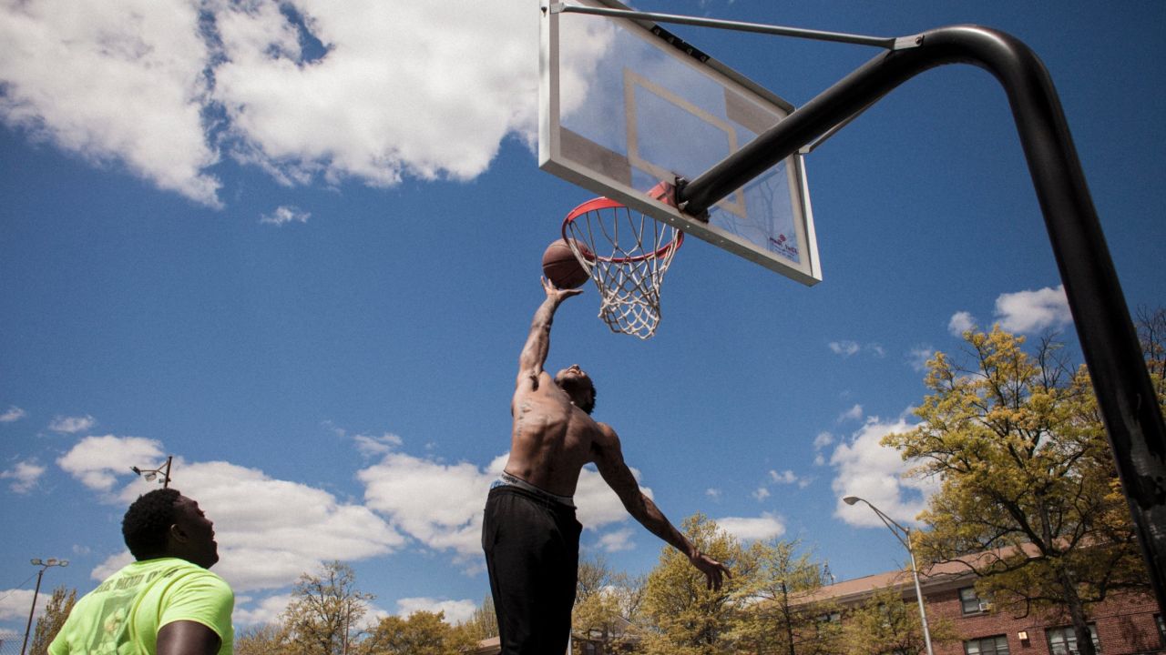 Two men play basketball in William Mcabee Park.