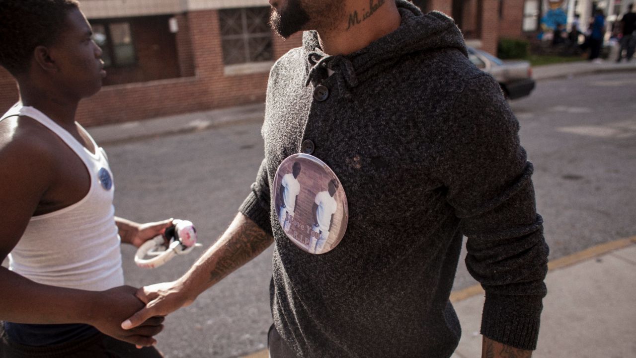 Gray's brother-in-law, Juan Grant, right, has become active in the community, speaking out against police brutality and racial profiling. He is also working toward a real estate license in hopes of being able to help rejuvenate the abandoned row houses that surround Gilmor Homes.