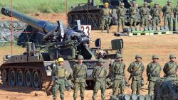Taiwan military soldiers stand guard next to a 155-millimeter howitzer during the Han Kuang 31 live fire drill in Hsinchu, northern Taiwan, on September 10, 2015. President Ma Ying-jeou presided over a live-fire anti-landing drill, part of the annual five-day war games simulating an invasion by China.  AFP PHOTO / Sam Yeh        (Photo credit should read SAM YEH/AFP/Getty Images)