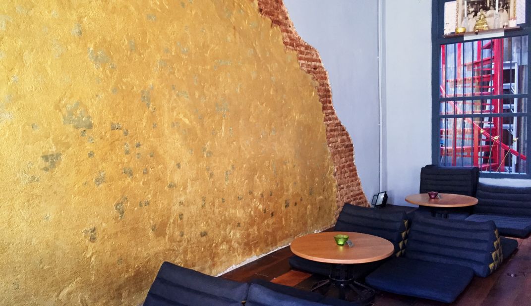 Swaths of gold-covered brick are exposed amongst otherwise concrete walls at Tep. It's a nod to ancient times when the Siamese buried golden Buddhas in cement to hide them from invaders.