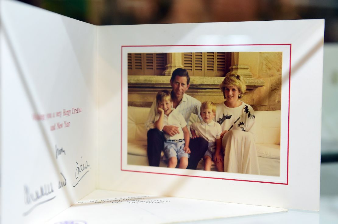 A 1987 Christmas card signed by Prince Charles and Princess Diana with their children, Prince William and Prince Harry.