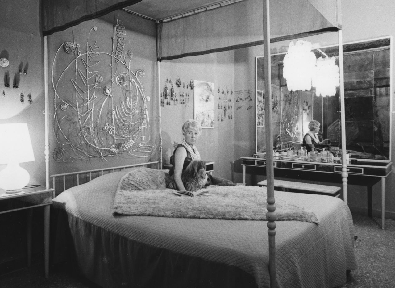 Peggy Guggenheim in her Venice palazzo. Behind her is an Alexander Calder bed head, comissioned by Guggenheim.