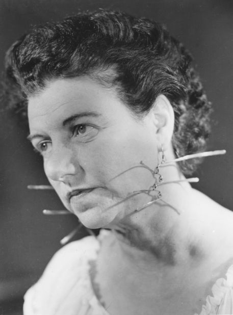 Peggy Guggenheim wearing a pair of earrings made for her by Alexander Calder; 1950s. The daughter of Benjamin Guggenheim, she inherited a not inconsiderable sum of money after the death of her father aboard the Titanic, using some of it to travel to Paris, where she began investing in Modern art.