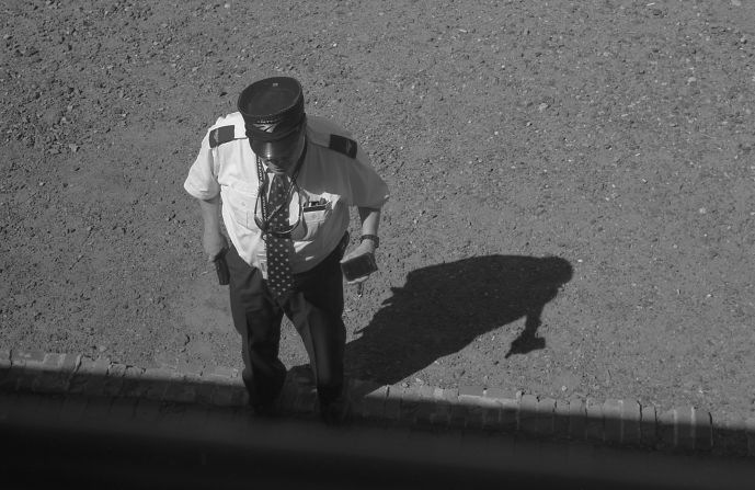 An Amtrak employee stands on a train platform along the Southwest Chief route. The Chief runs more than 2,000 miles through eight states between Chicago and Los Angeles. 