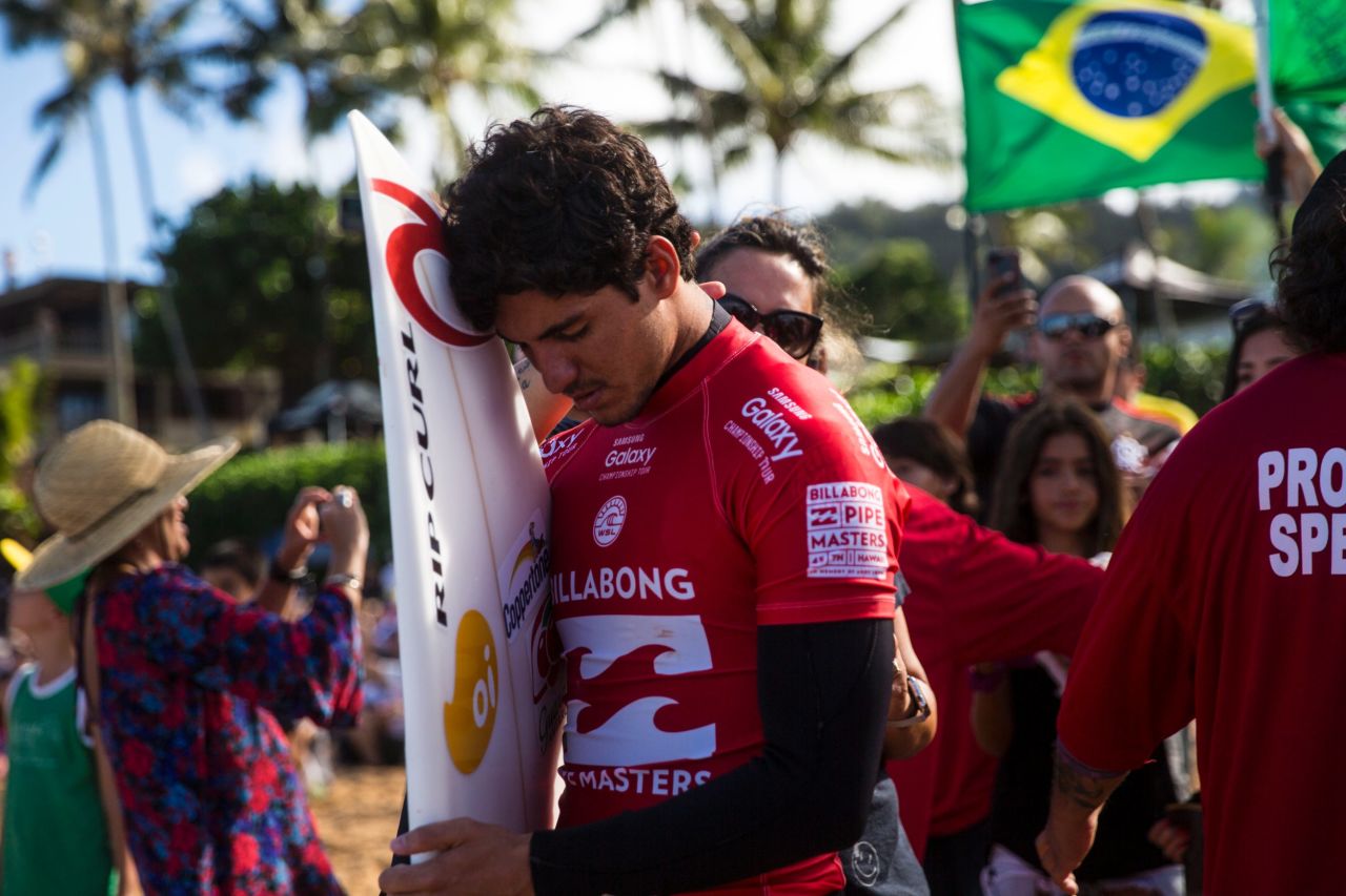 Surfer Gabriel Medina of Brazil pauses for a moment before running into the water at Ehukai Beach Park on December 17.