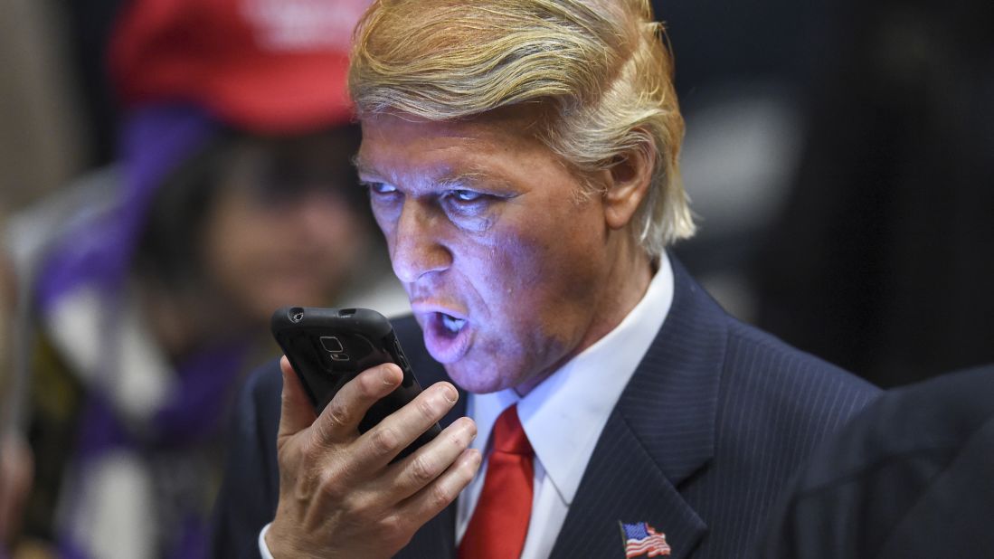 Donald Trump impersonator Robert S. Ensler speaks on a phone before the presidential hopeful holds a rally in Las Vegas on Monday, December 14.