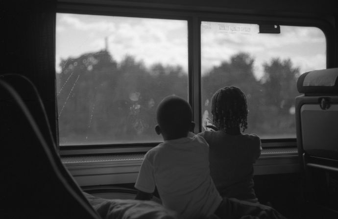 Two children peer out the window of Amtrak's Southwest Chief train as it rolls west.