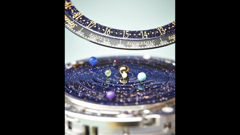 This watch displays the sun in the center, with small representations of planets in orbit around it.  