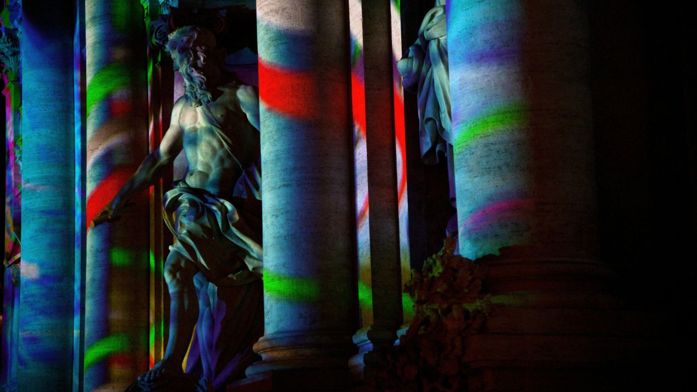 The 18th-century Baroque-style Trevi Fountain is lit with colors as part of Rome's canditature for the 2024 Olympic Games.
