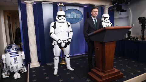 U.S. Press Secretary Josh Earnest speaks to the press in the briefing room at the White House in Washington, DC, on December 18, 2015, with Star Wars characters R2D2 and Storm Troopers.
