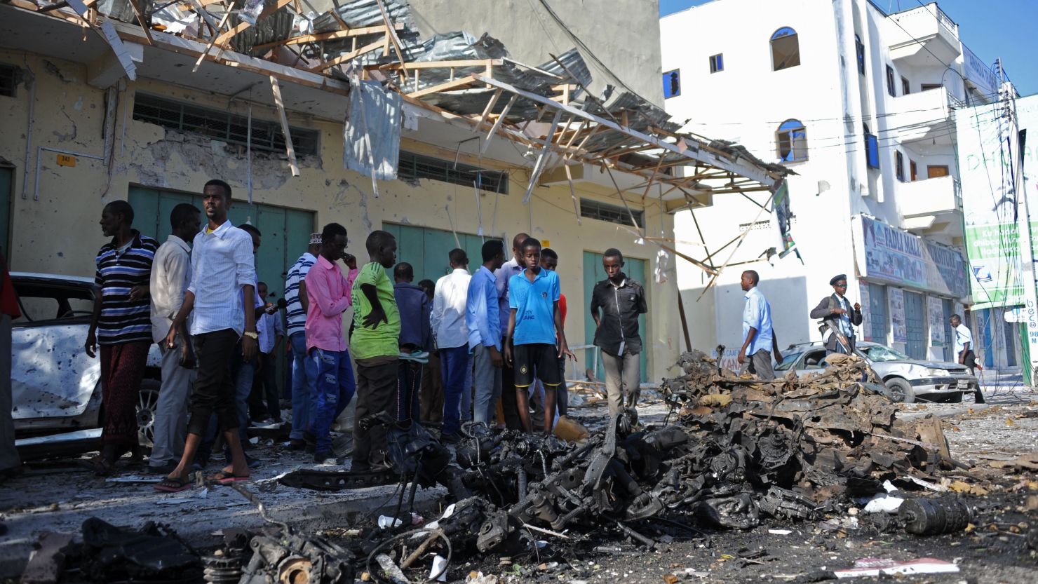 People gather at the site of a deadly bomb blast in Mogadishu on Saturday, 
