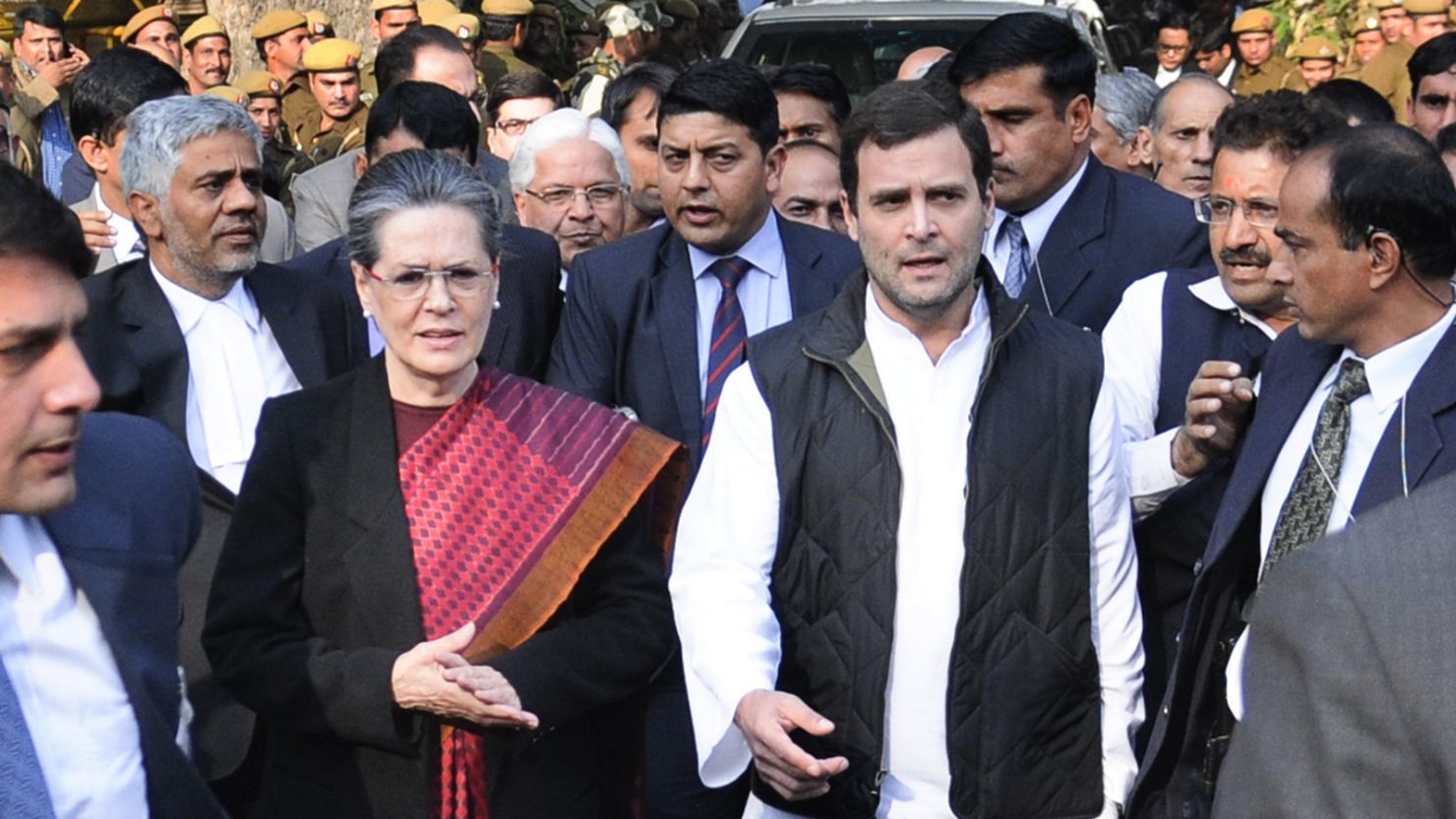 Congress party president Sonia Gandhi and her son Rahul Gandhi leave court after being granted bail.