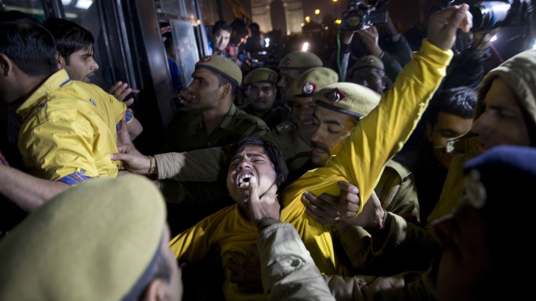 An Indian man shouts slogans as he is detained by police during the protest.