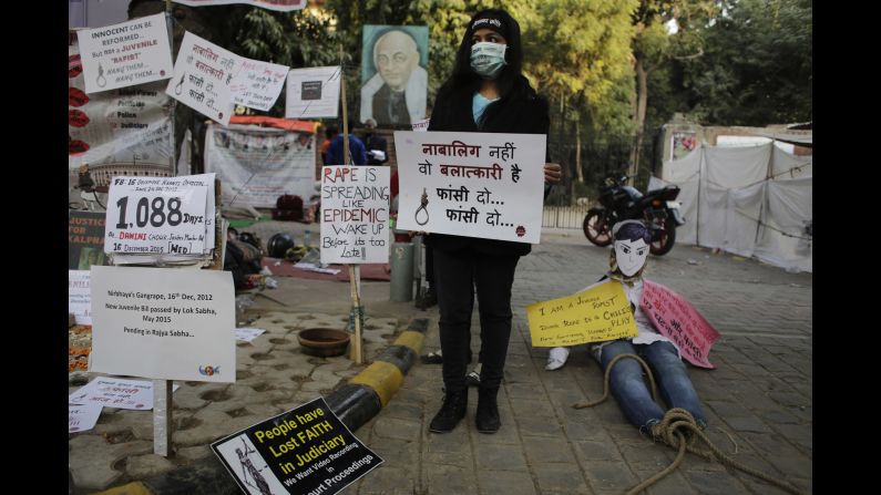 An Indian woman holds a placard which reads, "He is not a juvenile but a rapist, hang him" on Wednesday, December 16, during a demonstration to commemorate the third anniversary of the fatal 2012 rape.