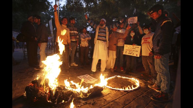 Protesters shout slogans as they burn an effigy of the juvenile convicted in the gang rape case during a protest in New Delhi on December 16, the third anniversary of the incident.