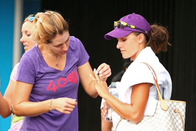 It was the third time Rodionova had lost the playoff final for the Australian Open -- where she was beaten in the first round in her only two singles appearances, in 2011 and 2015. Here she shows Ukrainian player Olga Savchuk her wedding ring. 