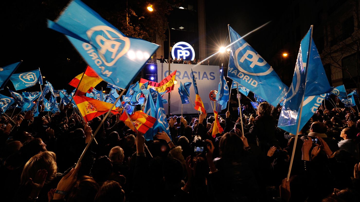Partido Popular supporters wave to Spanish Prime Minister Mariano Rajoy on the balcony after his party won the most votes on December 20, 2015 in Madrid, Spain.