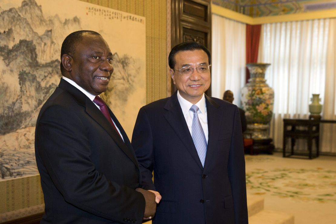Ramaphosa (L) shakes hands with Chinese Premier Li Keqiang in 2015.