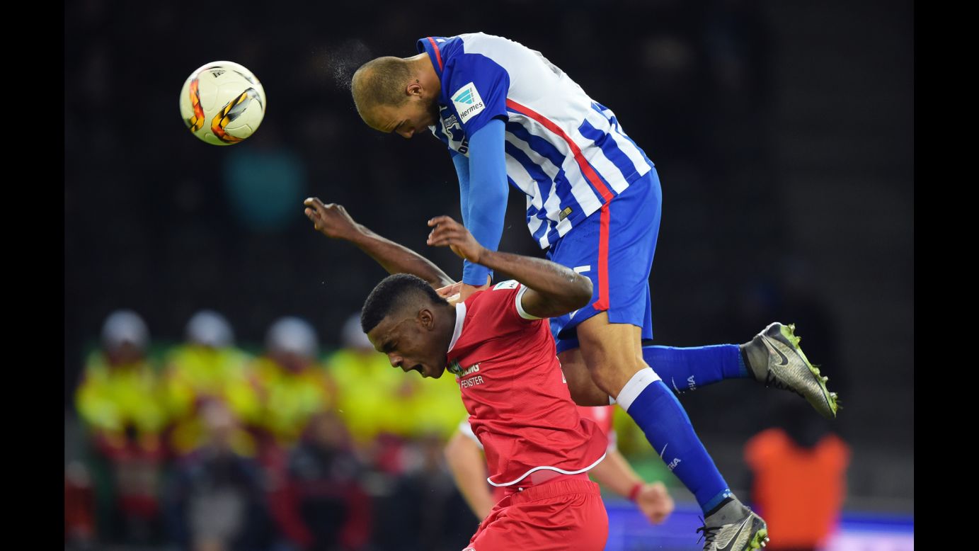 John Anthony Brooks of Hertha BSC dives over Jhon Cordoba of FSV Mainz 05 during a match on Sunday, December 20, in Berlin. 