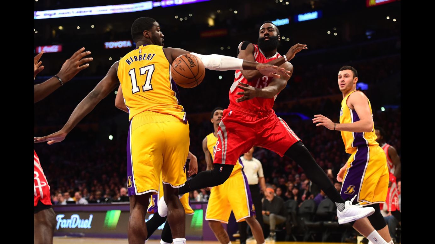 James Harden of the Houston Rockets passes behind Roy Hibbert of the Los Angeles Lakers at Staples Center in Los Angeles on Thursday, December 17.<br />