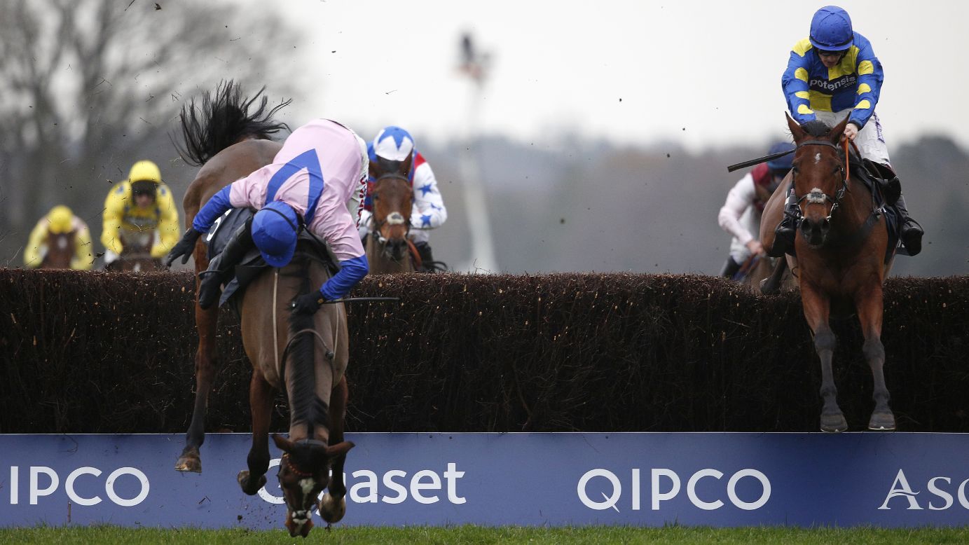 Harry Skelton, riding Amore Alato, falls off his horse during the Mitie Novices' Steeple Chase at the Ascot Racecourse in England on Friday, December 18.<br />