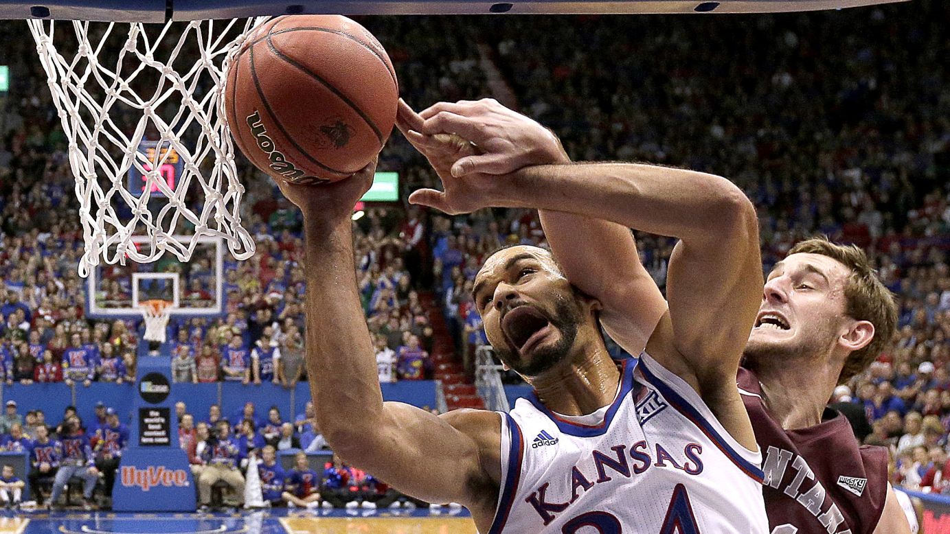 Montana's Jack Lopez fouls Kansas' Perry Ellis as he puts up a shot during the first half of an NCAA college basketball game in Lawrence, Kansas, on Saturday, December 19.