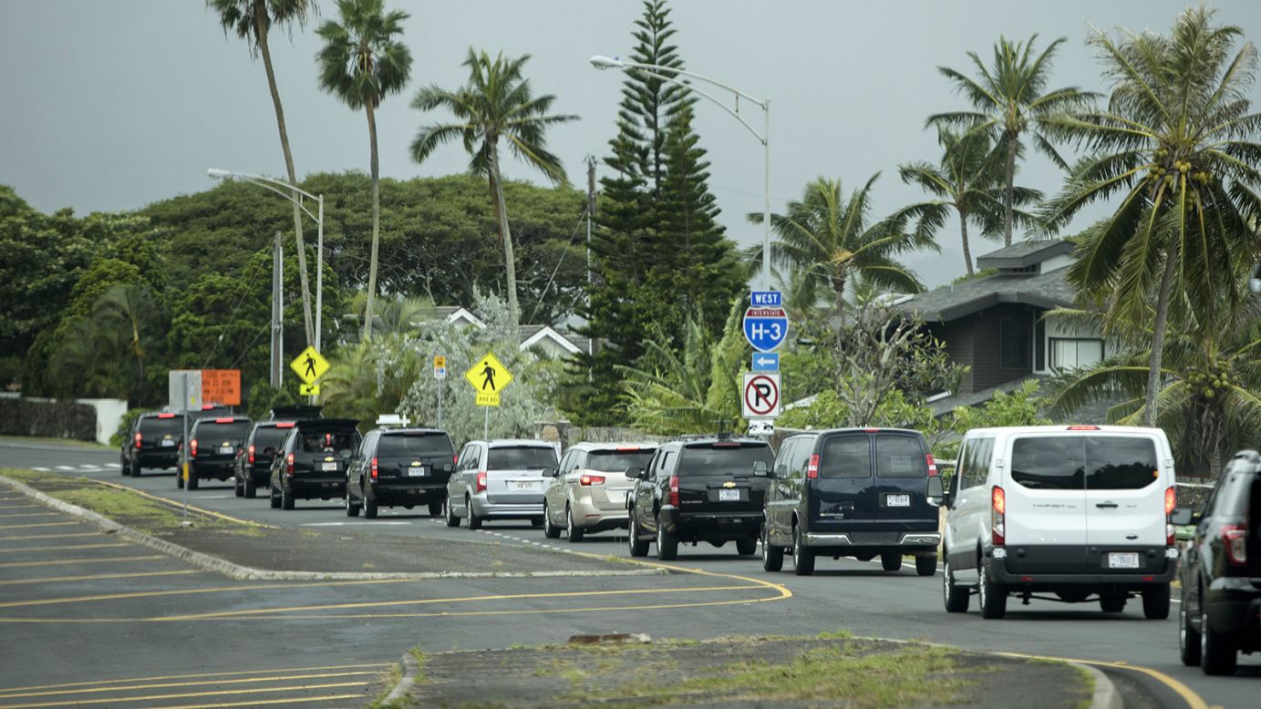 A motorcade takes the Obama family to a hike in Honolulu on Sunday.