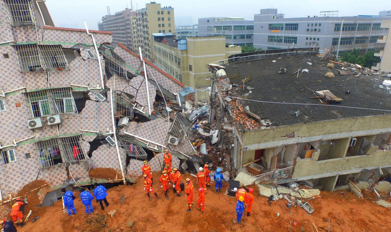 Chinese rescuers work at the land slidesite. The landslide that hit southern China's Shenzhen on December 20, 2015 was China's second industrial disaster in four months. 