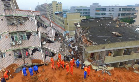Chinese rescuers work at the land slidesite. The landslide that hit southern China's Shenzhen on December 20, 2015 was China's second industrial disaster in four months. 
