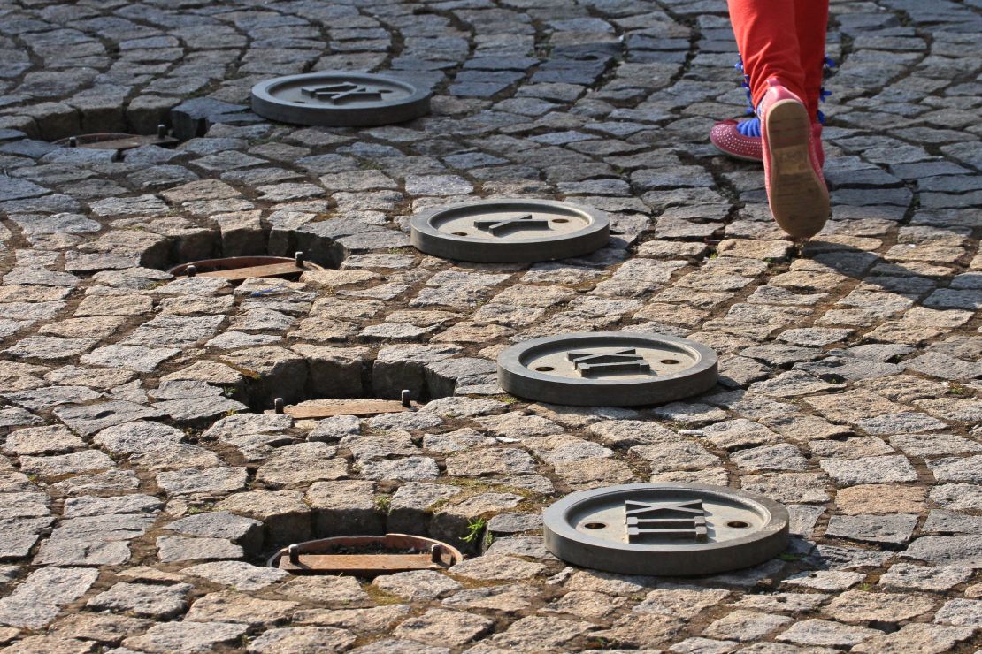 A child walks on a sundial on a square in Trest, Czech Republic.