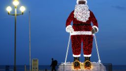 TOPSHOT - A giant illuminated Santa Claus model is displayed along the "Promenade des Anglais" in the French Riviera city of Nice, southeastern France, on December 12, 2015.  / AFP / VALERY HACHE        (Photo credit should read VALERY HACHE/AFP/Getty Images)