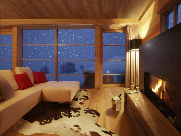 The ground-level living area has a wooden terrace offering superb views of the Dolomites, an open log fire place, TV and Wi-Fi.  