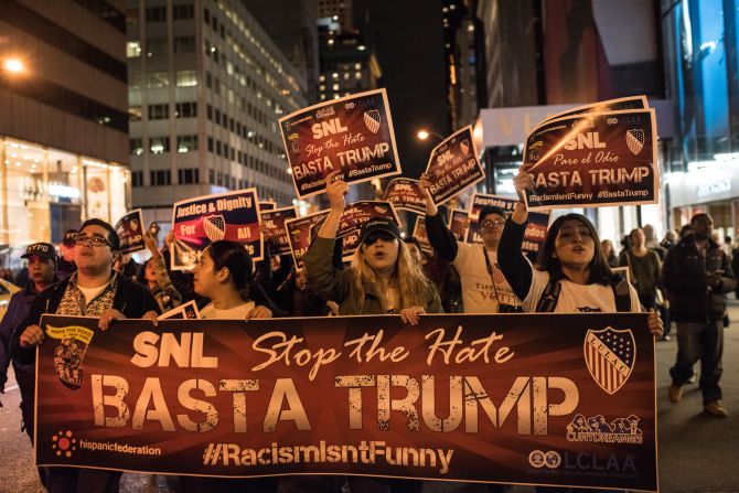 Members of Latino organizations march from the Trump Tower to NBC studios in New York to protest Trump's "Saturday Night Live" appearance on November 7.
