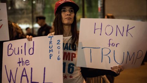 A Trump supporter stands across the street from the Latino protest in New York on November 7.