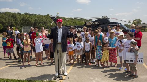 Trump speaks with reporters after arriving at the Iowa State Fair in Des Moines on August 15. Trump gave children rides on his helicopter.