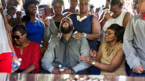 Michael Brown Sr. yells out as the casket of his son Michael is lowered into the ground during his funeral at St. Peters Cemetery in August 2014 in St. Louis. 