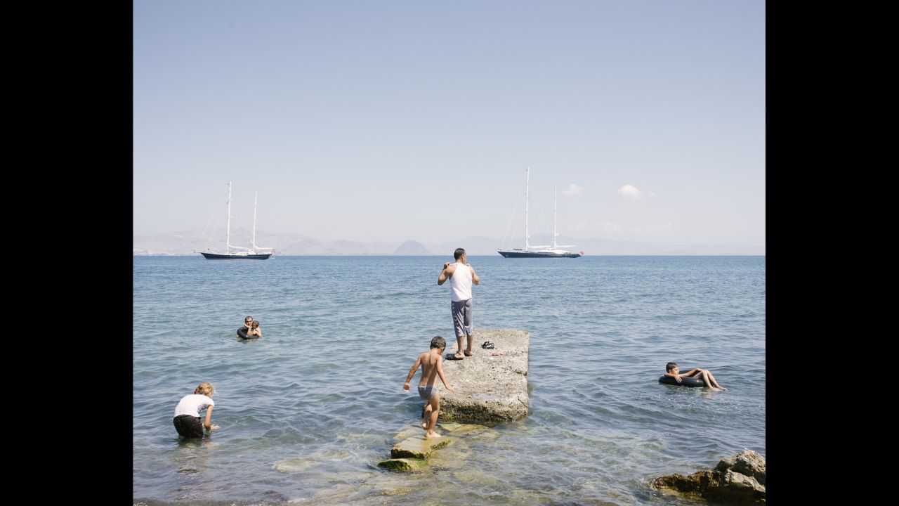 Migrants bathe in the Mediterranean Sea.