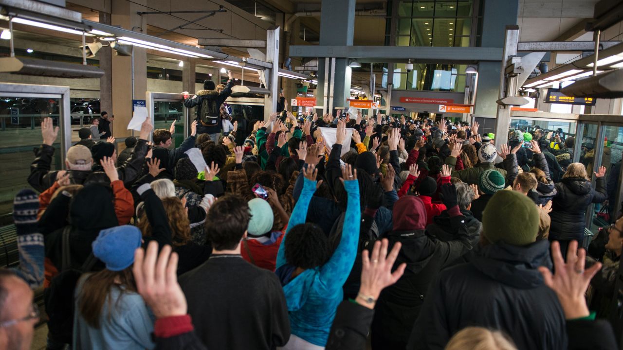 Black Lives Matter protesters hold their hands in the air and chant, "Hands up, don't shoot" at the Minneapolis-St. Paul International Airport light rail stop in Minneapolis on Wednesday, December 23.