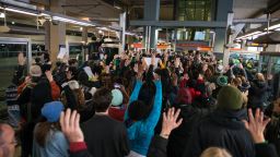 MINNEAPOLIS, MN -  DECEMBER 23:  Black Lives Matter protestors hold their hands in the air and chant, "Hands up, don't shoot," at the Minneapolis-St. Paul International airport Lightrail stop on December 23, 2015 in Minneapolis, Minnesota. Black Lives Matter Minneapolis staged a brief protest at the Mall of America in Bloomington, MN before moving their protest to the airport. (Photo by Stephen Maturen/Getty Images)