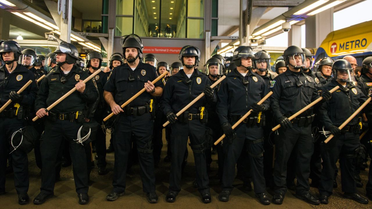 Police line up at the rail stop, where Black Lives Matter protesters attempted to enter the airport Wednesday.